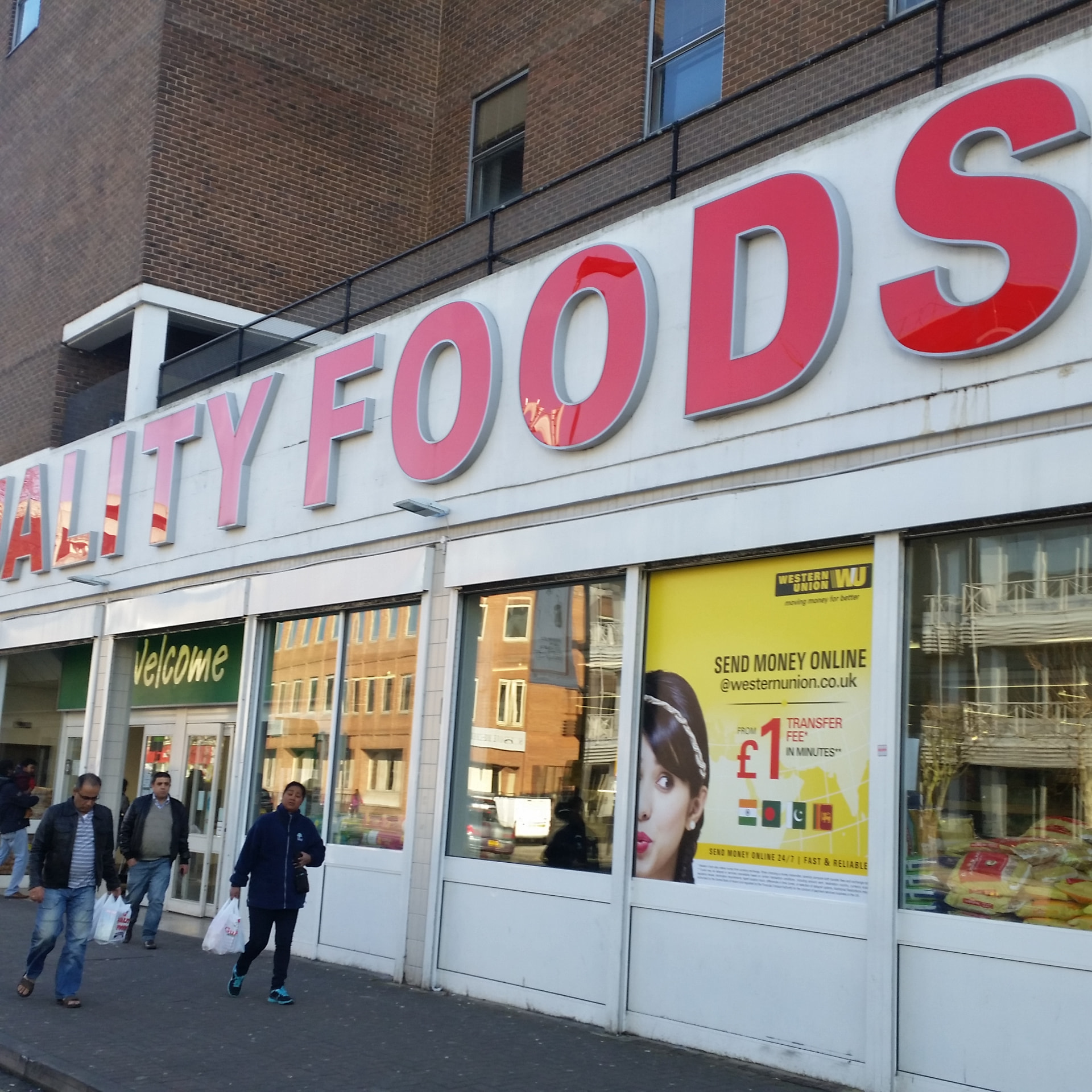 Western Union window advertising at Quality Foods supermarket